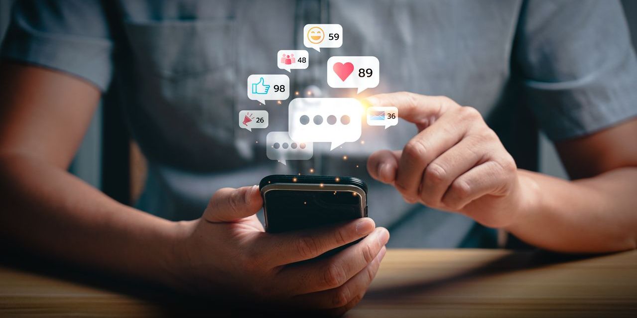 man using social media in recovery