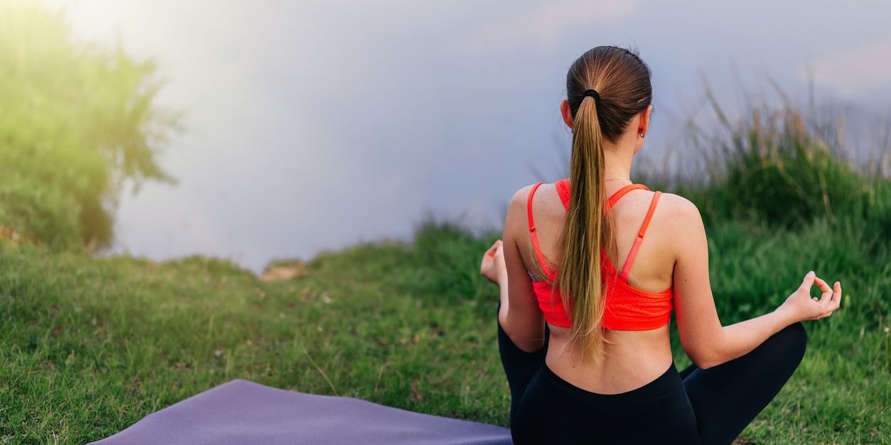 woman doing yoga outdoors which can help with opioid withdrawal symptoms