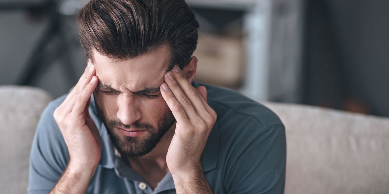 man experiencing hangover from alcohol relapse